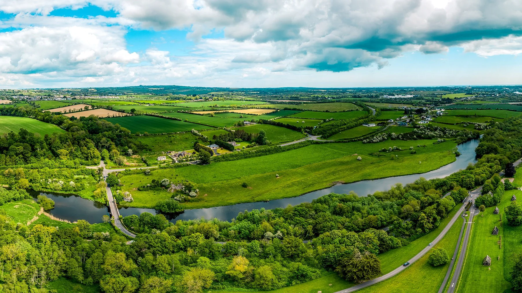 Farmland, homes and a river in the Irish midlands, seen from above