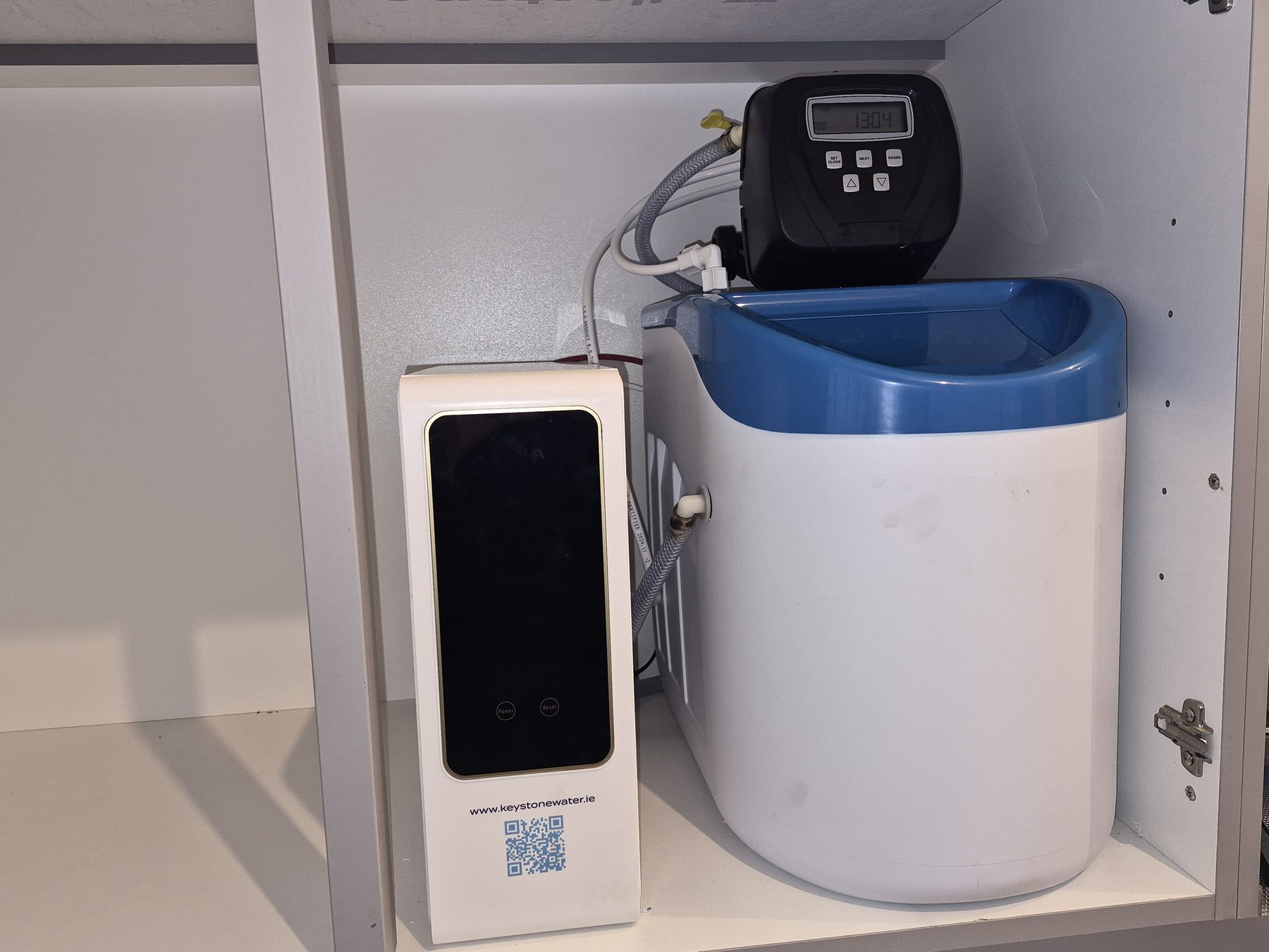 A compact water softener fitted in a utility cabinet to tackle limescale