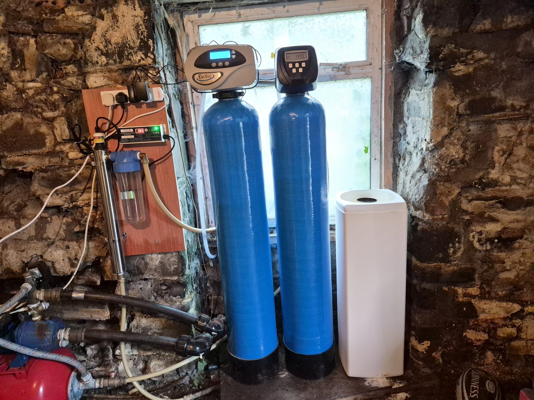 Whole-home water treatment tanks fitted to a private well supply