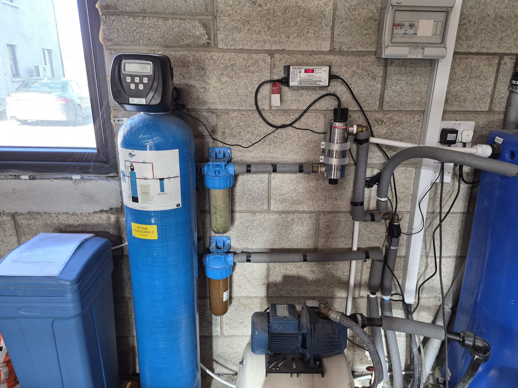 Whole-home water filtration system installed on a supply